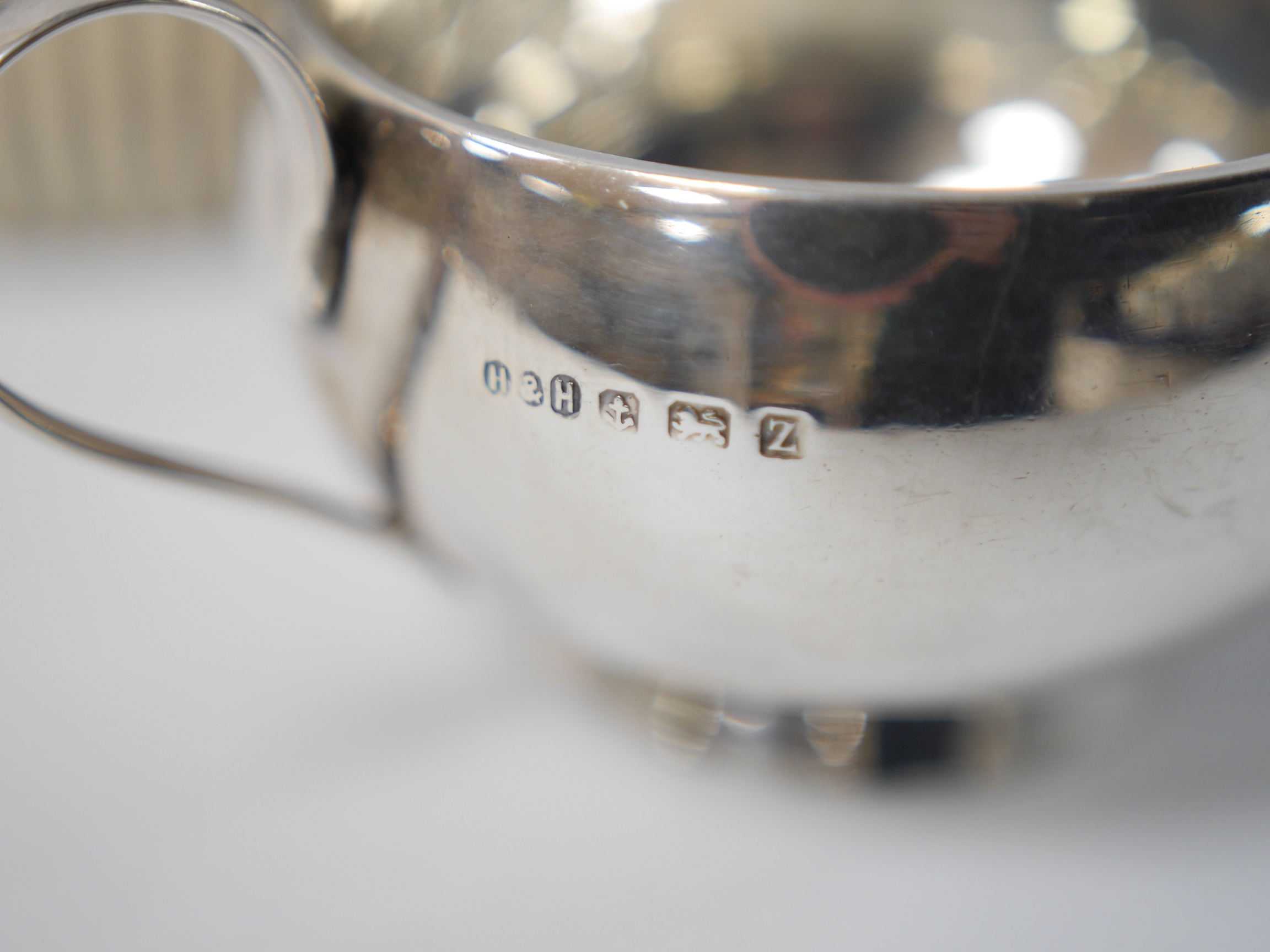 A late Victorian bachelor's demi-fluted silver teapot, Birmingham, 1894, together with a George V silver two handled bowl by Hukin & Heath, gross weight 11.3oz. Condition - fair